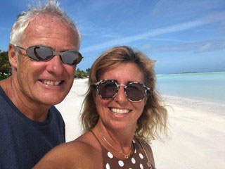 Carla and Simon Fowler on a white sand beach