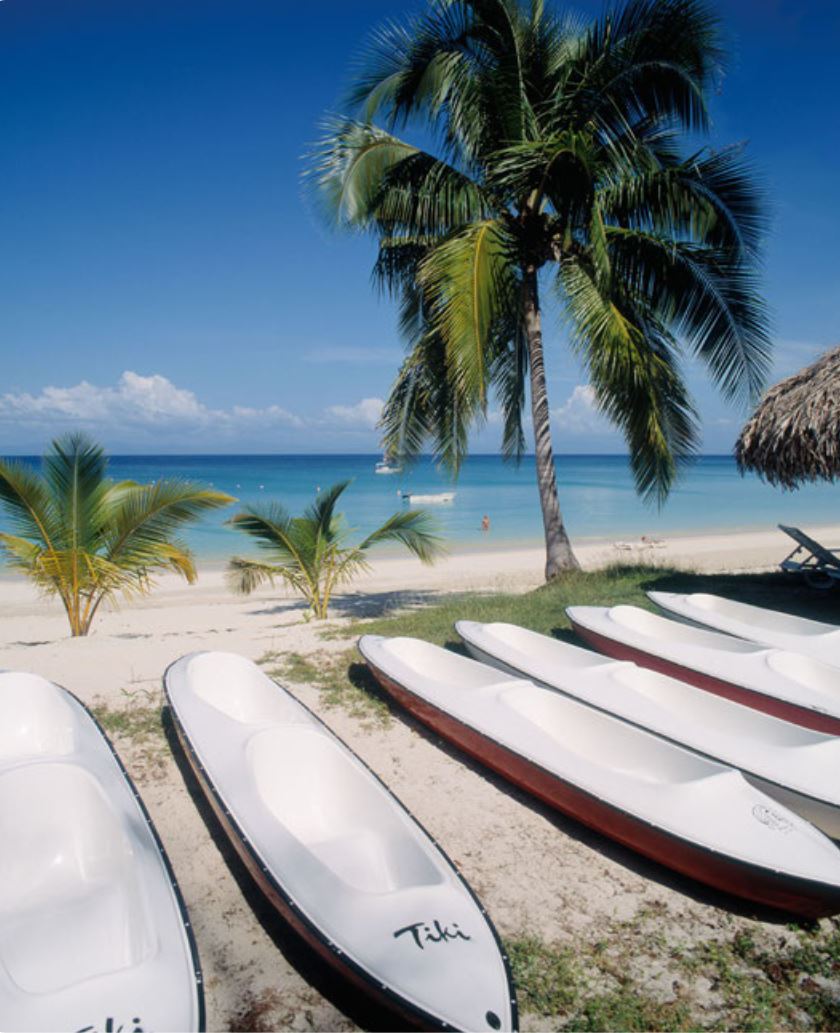 Kayaks on white sand beach